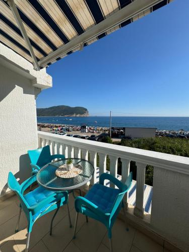 a balcony with a table and chairs and the ocean at Apartments Villa Marija in Petrovac na Moru
