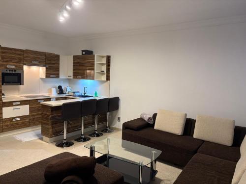 a living room with a couch and a kitchen at Donovaly Triangel A10 in Mistríky