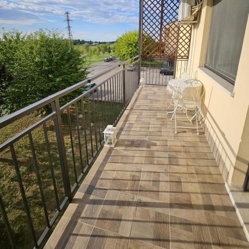 a balcony with a table and chairs on it at Appartamento Divino Tramonto in Altedo