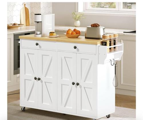 a white kitchen island with a wooden counter top at Maya Bed and Breakfast in Port Perry