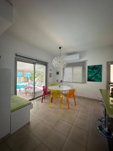 a kitchen and dining room with a table and chairs at Villa Serenity in Protaras