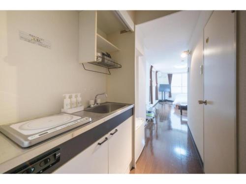 a kitchen with a sink and a counter top at R Hotel - Vacation STAY 19207 in Chiba