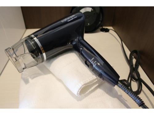 a blow dryer is sitting on a table at R Hotel - Vacation STAY 19689 in Chiba