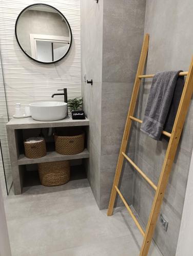 a bathroom with a sink and a mirror at DS Elegant Apartment in Ermoupoli