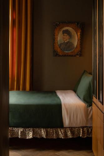 a bedroom with a bed with a painting on the wall at Maison Lezard in Mexico City