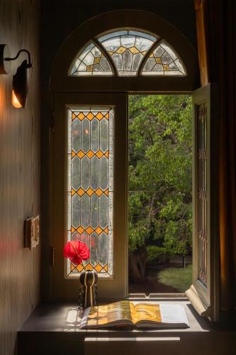 an open window with a book on a window sill at Maison Lezard in Mexico City
