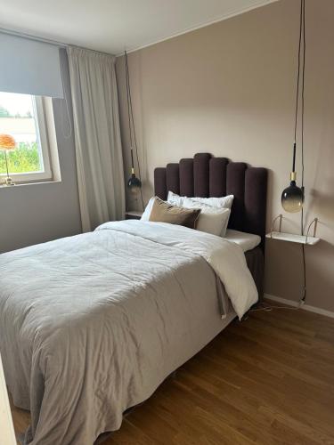 a bedroom with a large bed and a window at BresseInn in Enköping
