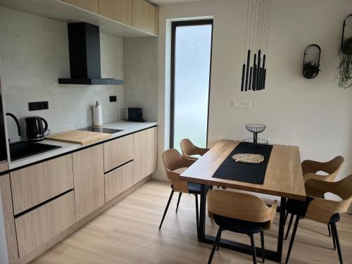 a kitchen and dining room with a table and chairs at Yacht club Barrandov in Kožlí u Orlíka