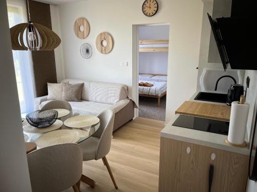 a living room with a couch and a table at Yacht club Barrandov in Kožlí u Orlíka