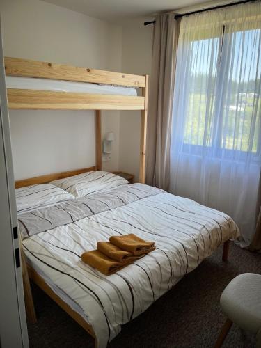 a bedroom with a bunk bed with two towels on it at Yacht club Barrandov in Kožlí u Orlíka