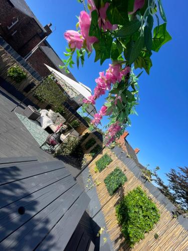 a tree with pink flowers in front of a building at The hidden barn in Easington