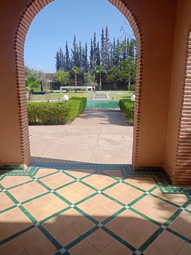 an archway leading to a courtyard with a fountain at Exceptional villa in Marrakech - privacy and comfort in Heddad