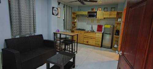 a kitchen with a chair and a table and a refrigerator at Ballena Rey Hotel in Uvita