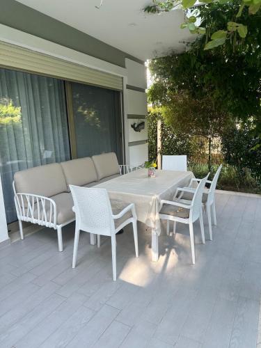 a white table and chairs on a patio at Villa Amalia Perla Resort in Draç