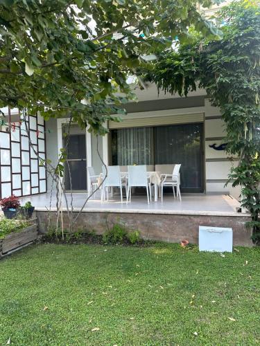 a table and chairs on the porch of a house at Villa Amalia Perla Resort in Draç
