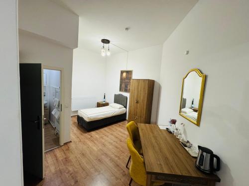 a living room with a wooden table and a mirror at HR RoomS in Hannover