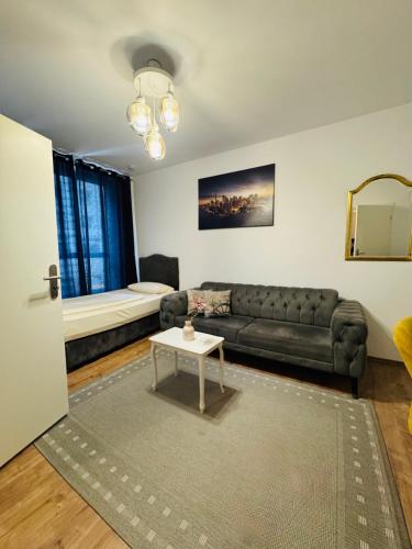 a living room with a couch and a table at HR RoomS in Hannover