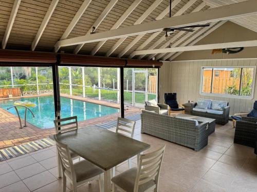 a living room with a table and chairs and a pool at Canal Home Dearborn-Indian Mound in Englewood