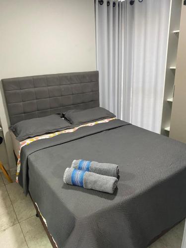 two towels sitting on top of a bed at Apartamento Premium Catolé in Campina Grande