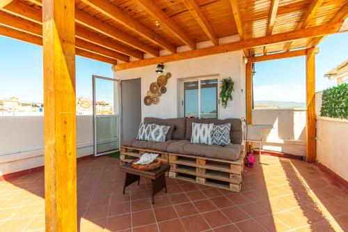 a living room with a couch on a patio at La Azotea - By Aloha Palma in Águilas