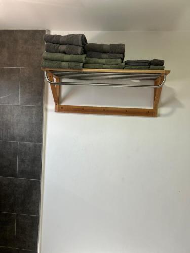 a shelf with towels on it in a bathroom at Ocean Breeze Apartment close to Mambo in Willemstad