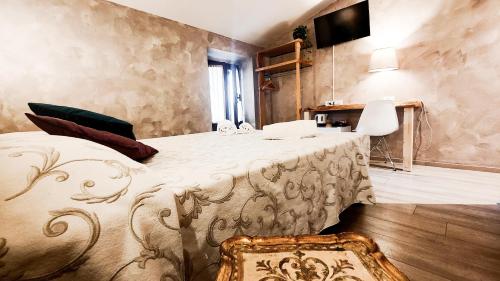 a bedroom with a bed and a television on the wall at Albergo B&B Tenesi in Manerba del Garda