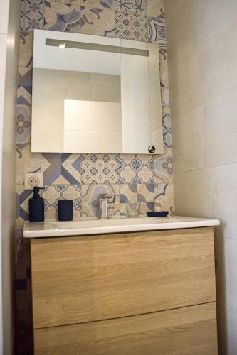 a bathroom with a sink and a mirror at CLOS MARIE in Iguerande