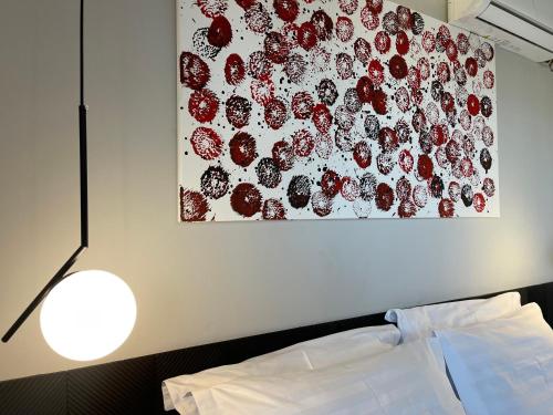 a painting on the wall above a bed and a lamp at XIX Boutique in Skopje