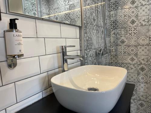 a bathroom with a white sink and a mirror at XIX Boutique in Skopje