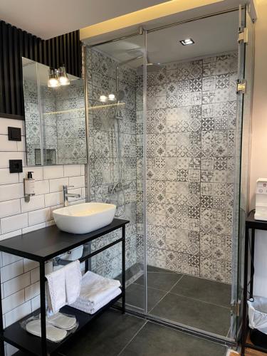 a bathroom with a sink and a shower at XIX Boutique in Skopje