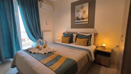 a bedroom with a bed with a flower on it at Evris House in Kavala