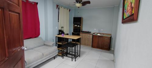 a living room with a couch and a table at Ballena Rey Hotel in Uvita