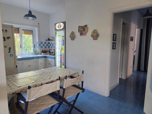 a kitchen with a table and a kitchen with a sink at Villa Mayla in Ippocampo