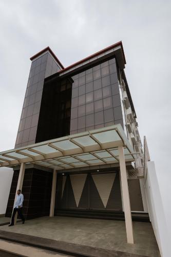 a man walks in front of a building at Dreamzz Comforts in Chikmagalūr