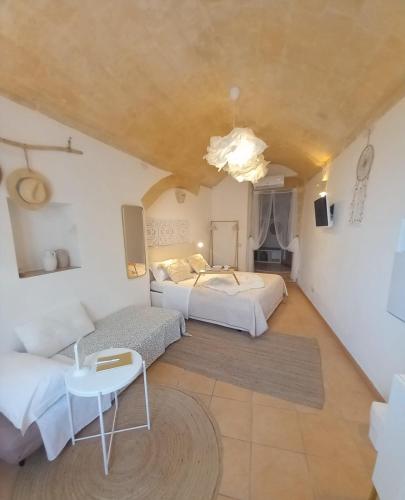 a large room with two beds and a couch at Animæ Caveoso Suite in Matera