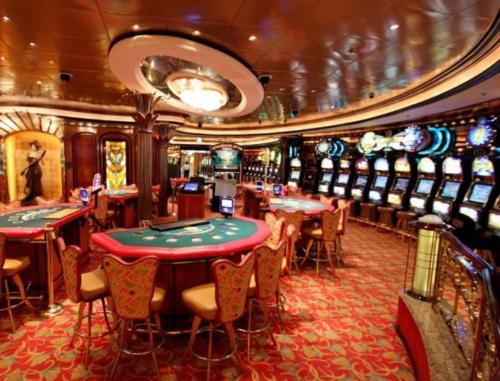a casino on a cruise ship with poker tables and chairs at Hotel La Tonnellerie in Spa