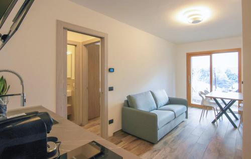 a living room with a blue couch and a table at B&B Passo del Cerreto in Cerreto Laghi