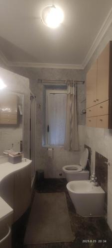 a bathroom with a white toilet and a sink at La casa di Betta in Lerici