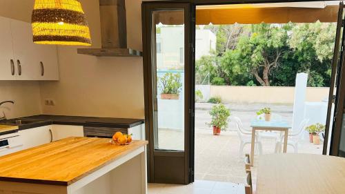 a kitchen with a view of a patio at Son Serra Holidays House ETV6786 in Son Serra de Marina