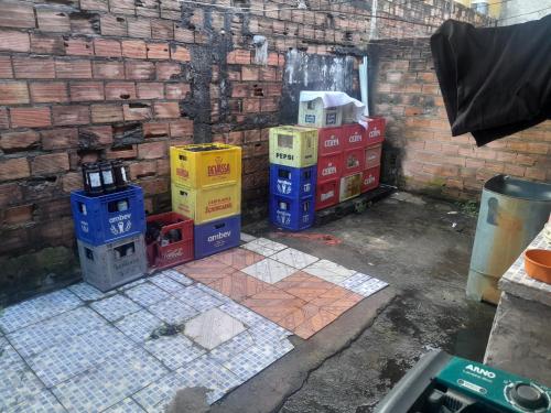 a pile of crates sitting next to a brick wall at Paraíso in Belém