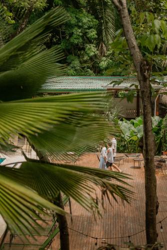 two women sitting on chairs in a park at ESO Santa Teresa in Santa Teresa Beach