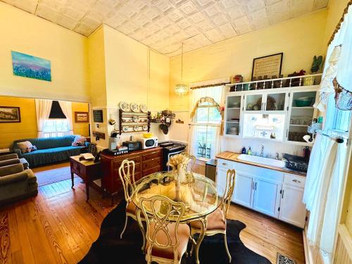 a kitchen and living room with a table and chairs at Circa 1900 - Historic - Romantic - Private - Pond - Fenced Yard - The Cottage at Chappell Hill in Chappell Hill