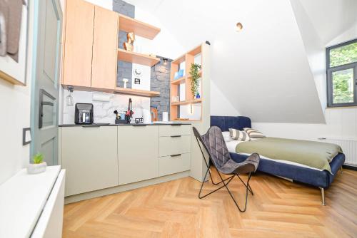 a kitchen with a bed and a chair in a room at Homly Nook in Rīga