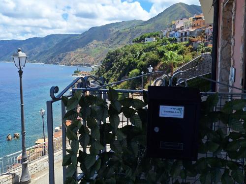 a view of the ocean from a balcony with a street light at Casa Vacanze Belvedere in Scilla