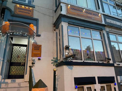 a store front of a building with a window at Aparthotel Coniston in Blackpool