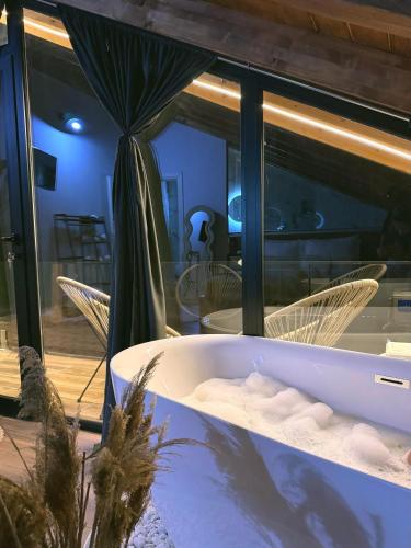 a bath tub with a palm tree in a room at Guesthouse Marashi in Theth