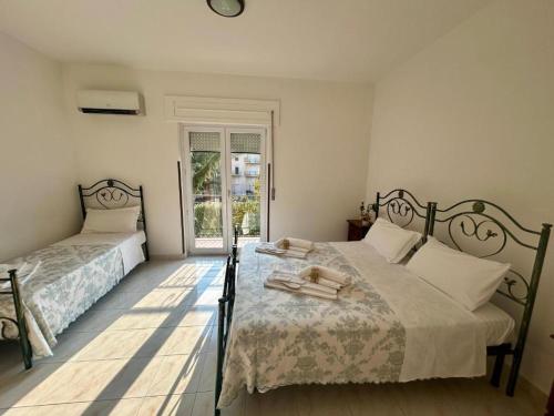 a bedroom with two beds and a window at Pollino Flower Park in Viggianello