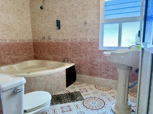 a bathroom with a tub and a toilet and a sink at Residence in Chignahuapan in Chignahuapan