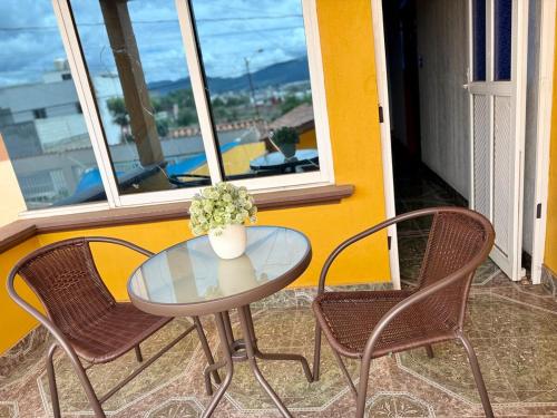 a glass table and two chairs on a balcony at Residence in Chignahuapan in Chignahuapan