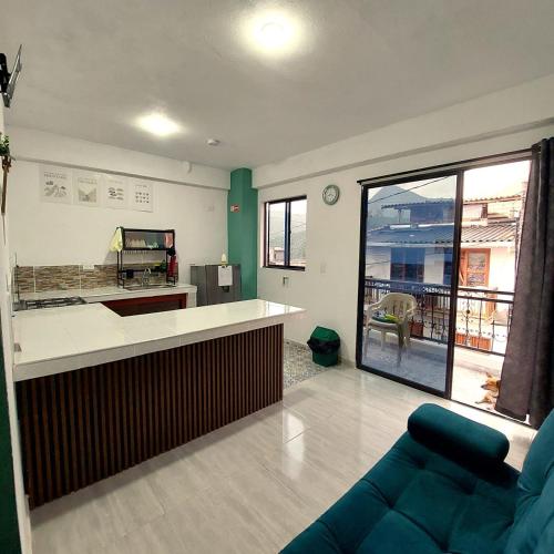 a living room with a kitchen and a couch at Apartamento en jardin in Jardin